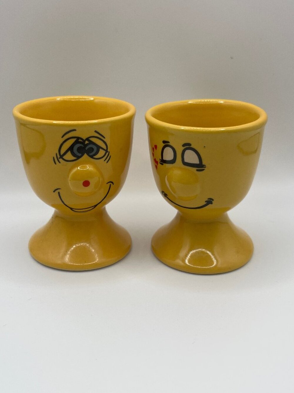 2 yellow ceramic "Funny Face" egg cups